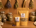 Stand up pouches with loose leaf tea sit on a shelf of an apothecary