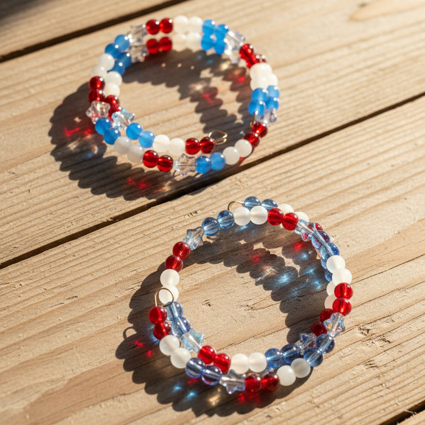 Two beaded stretch bracelets with red, white, and blue beads,