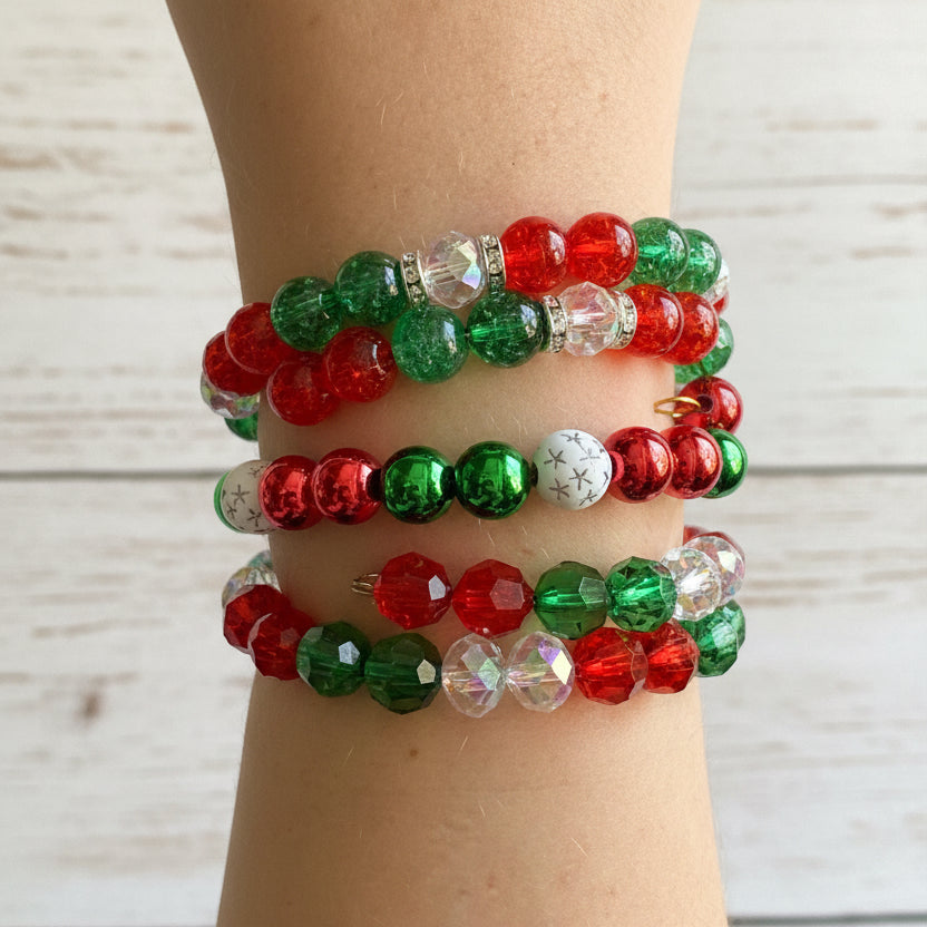 Three beaded stretch bracelets with red, green, and white beads, shown worn on a person's wrist 