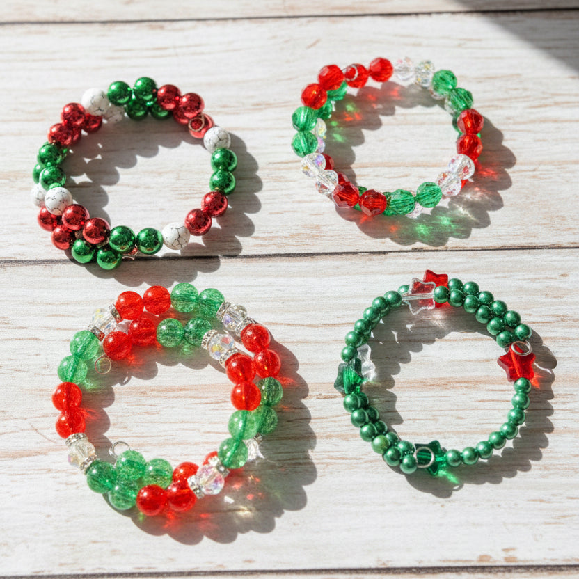 Four beaded stretch bracelets  The bracelets feature red, green, and white beads, with some clear faceted beads and small star-shaped charms.