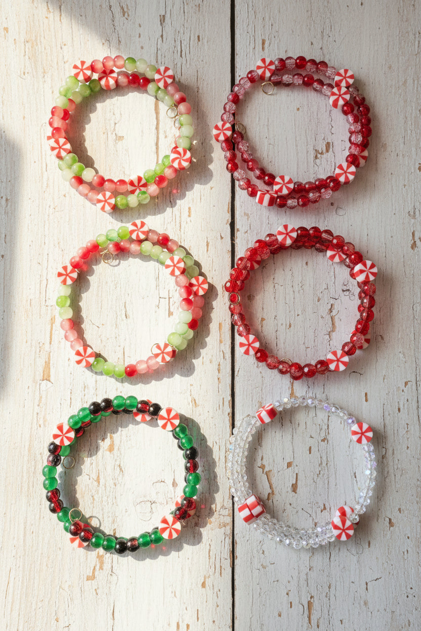 Six beaded stretch bracelets  featuring holiday candy cane and peppermint designs in red, green, white, and some clear beads.