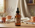 An amber glass dropper bottle with a black cap