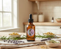 An amber glass dropper bottle  with a black cap,